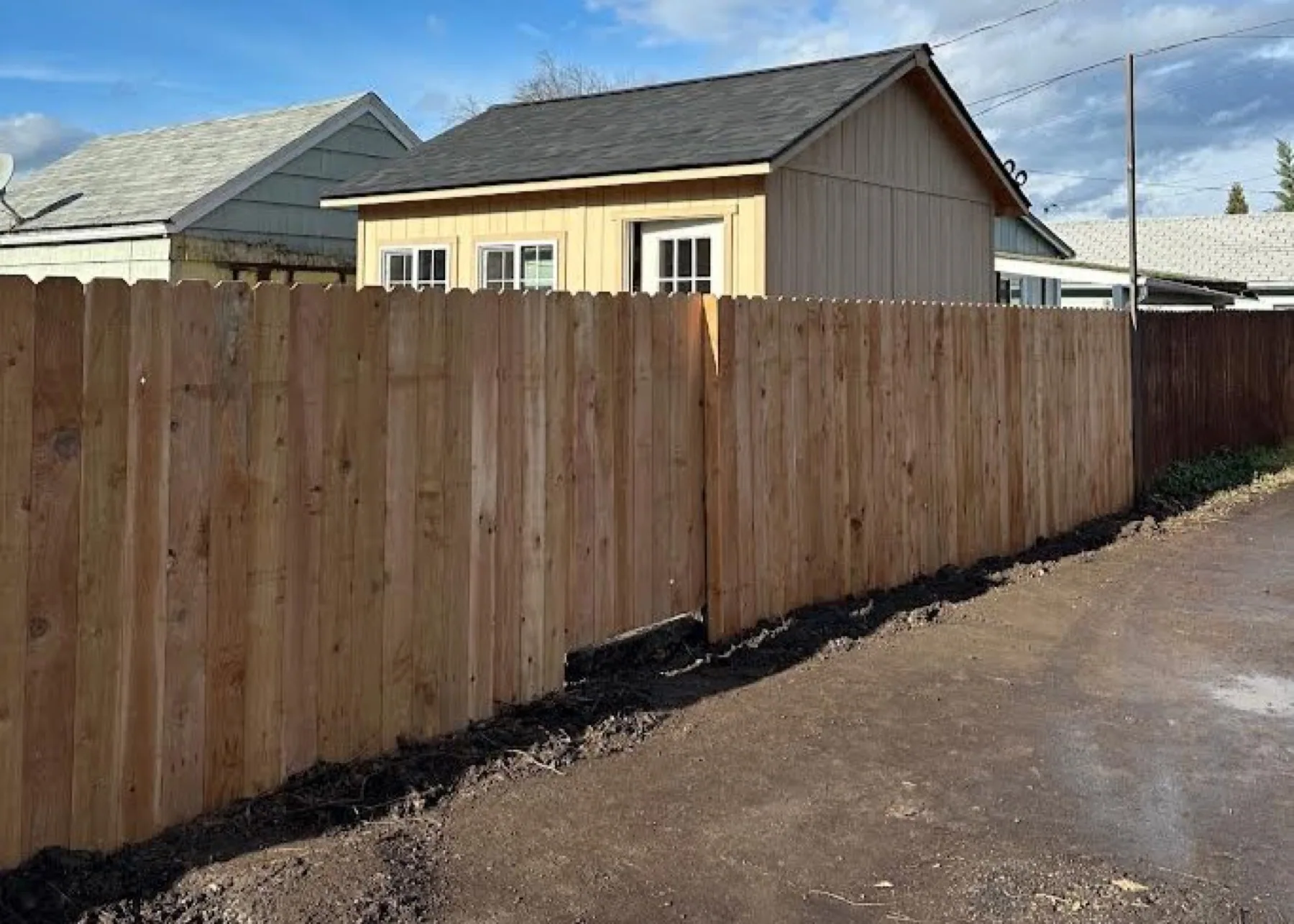 New wood privacy fence along a property line