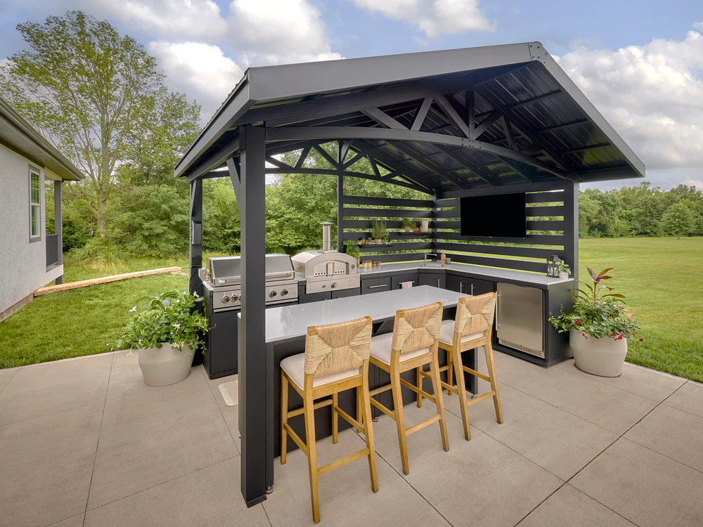 Covered outdoor kitchen with grill counters and seating