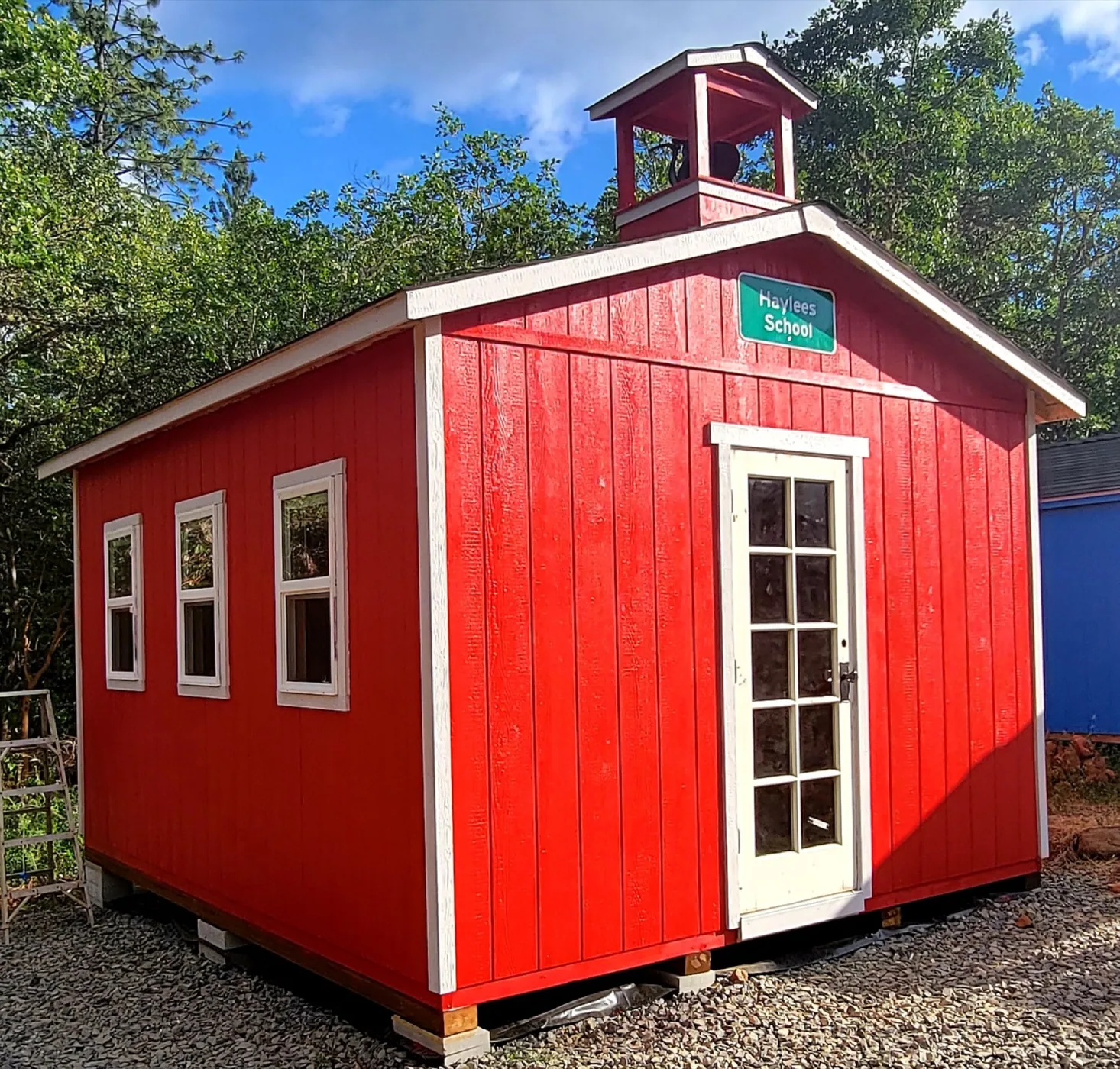 Red schoolhouse-style backyard playhouse